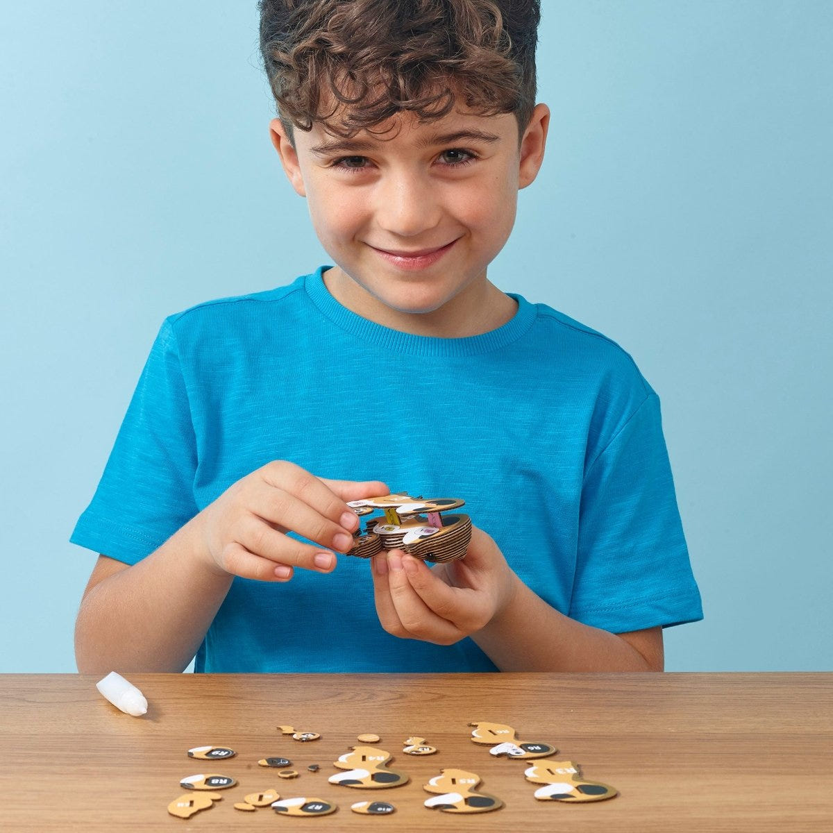 EUGY Meerkat 3D cardboard model kit - child assembling the model
