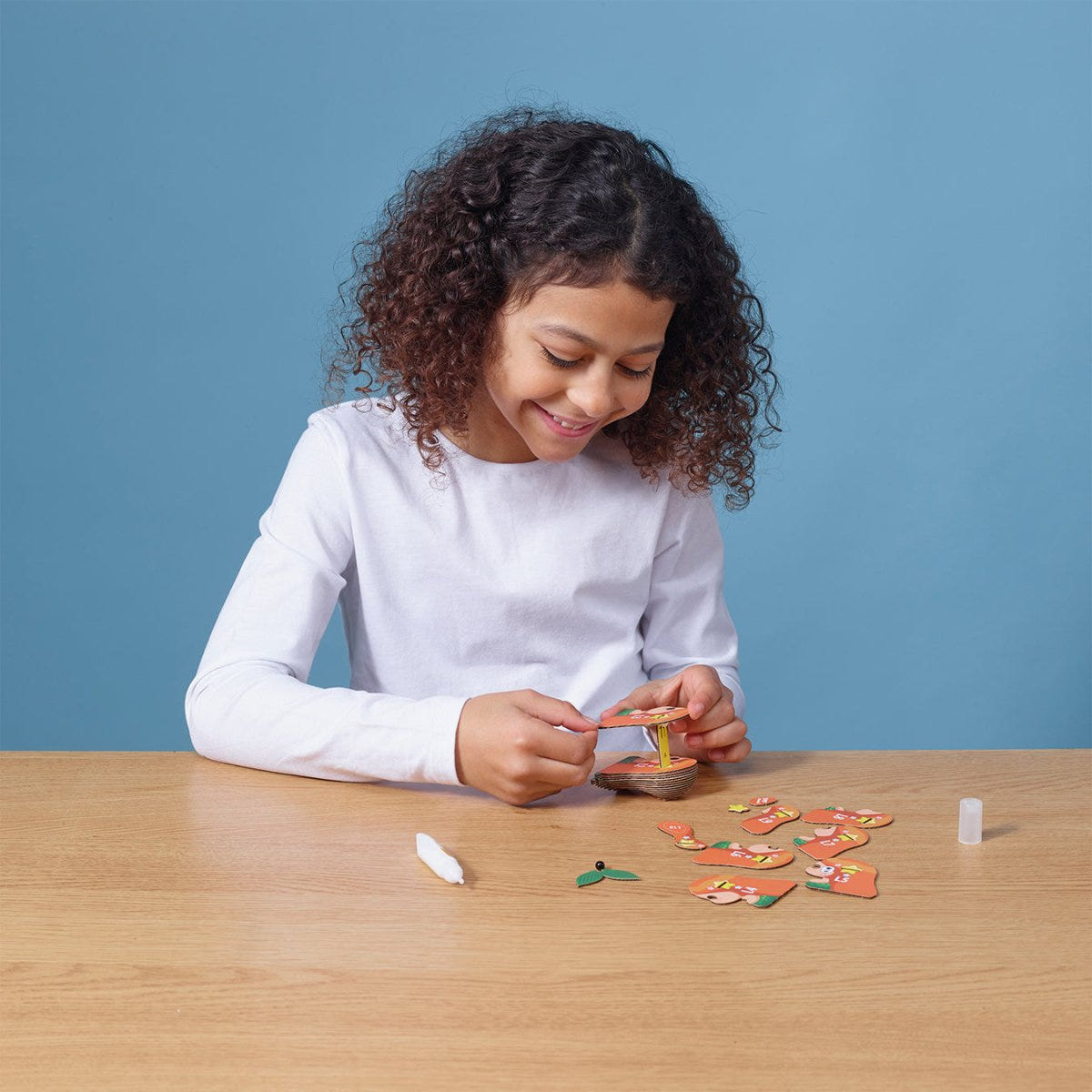 EUGY Mermaid 3D cardboard model kit - child assembling the model