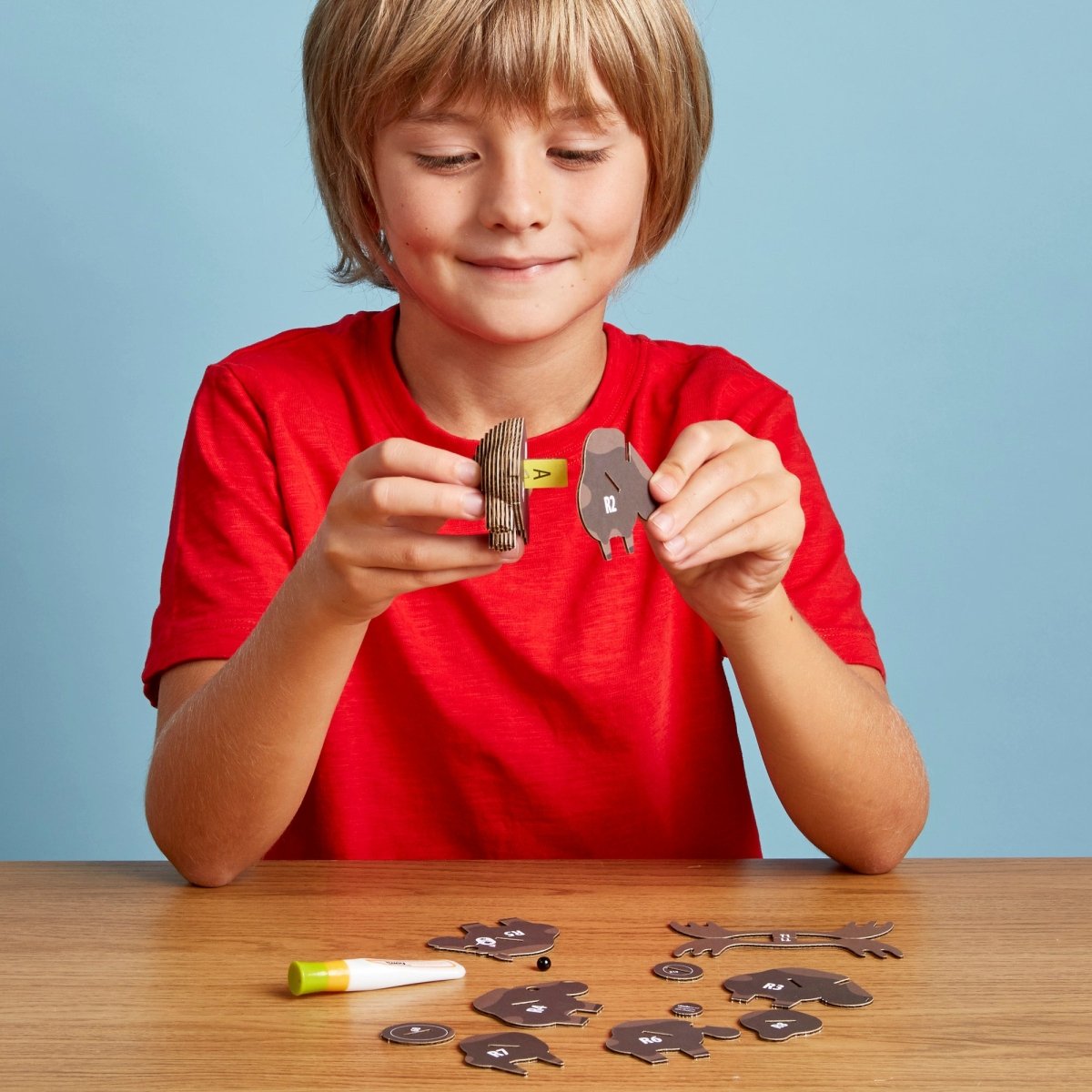 EUGY Moose 3D cardboard model kit - child assembling the model