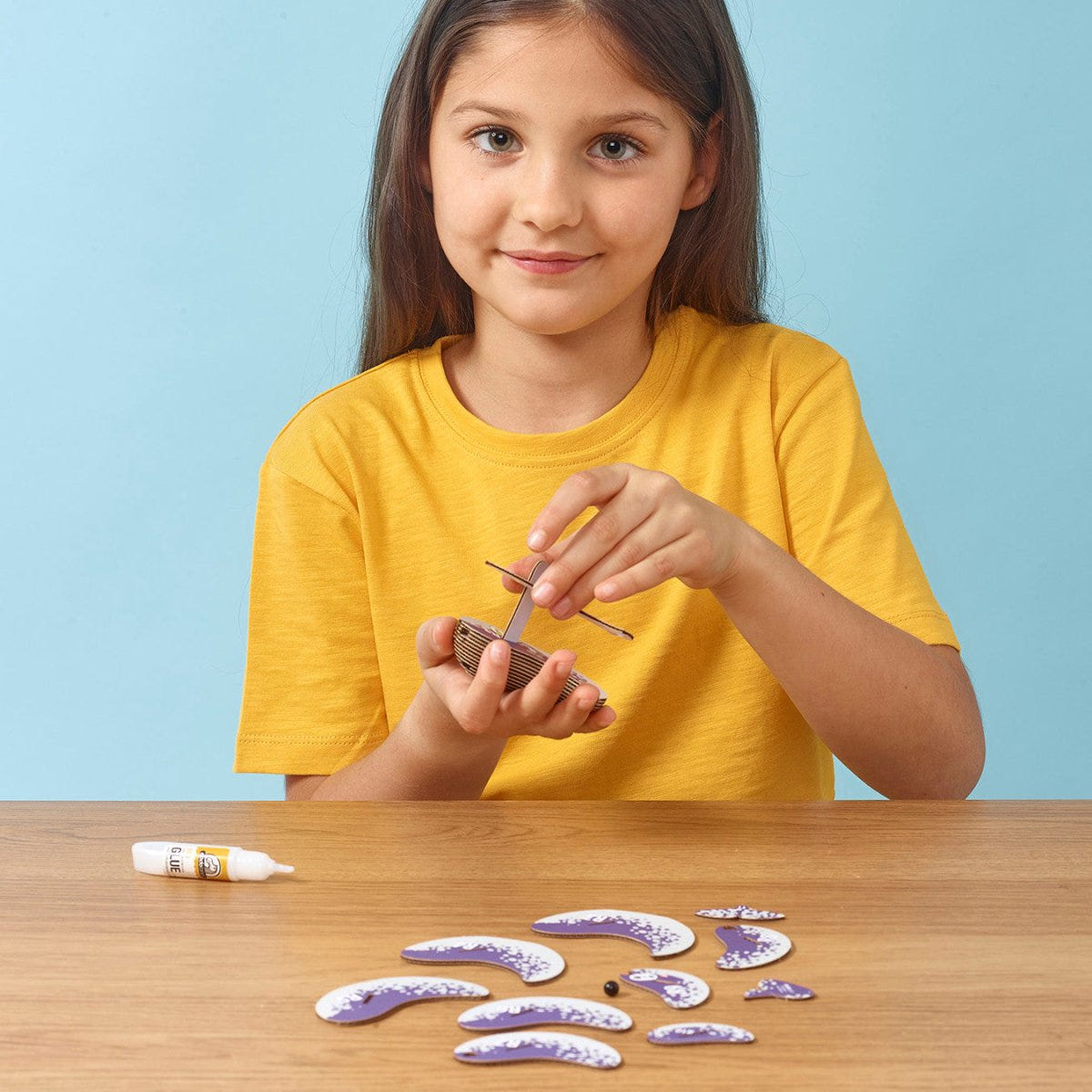 EUGY Narwhal 3D cardboard model kit - child assembling the model