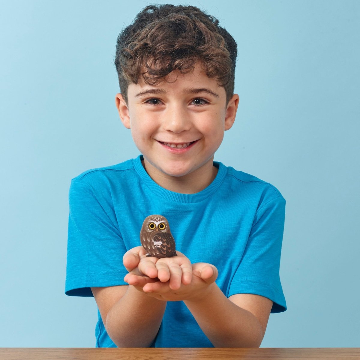 EUGY Owl 3D cardboard model kit - child with the finished model