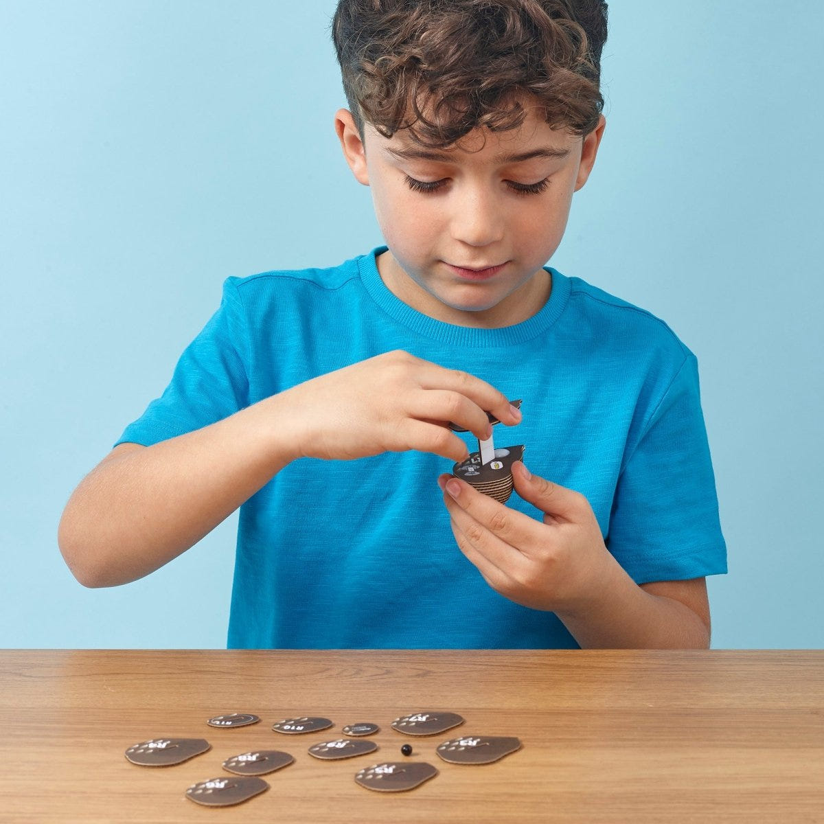 EUGY Owl 3D cardboard model kit - child assembling the model