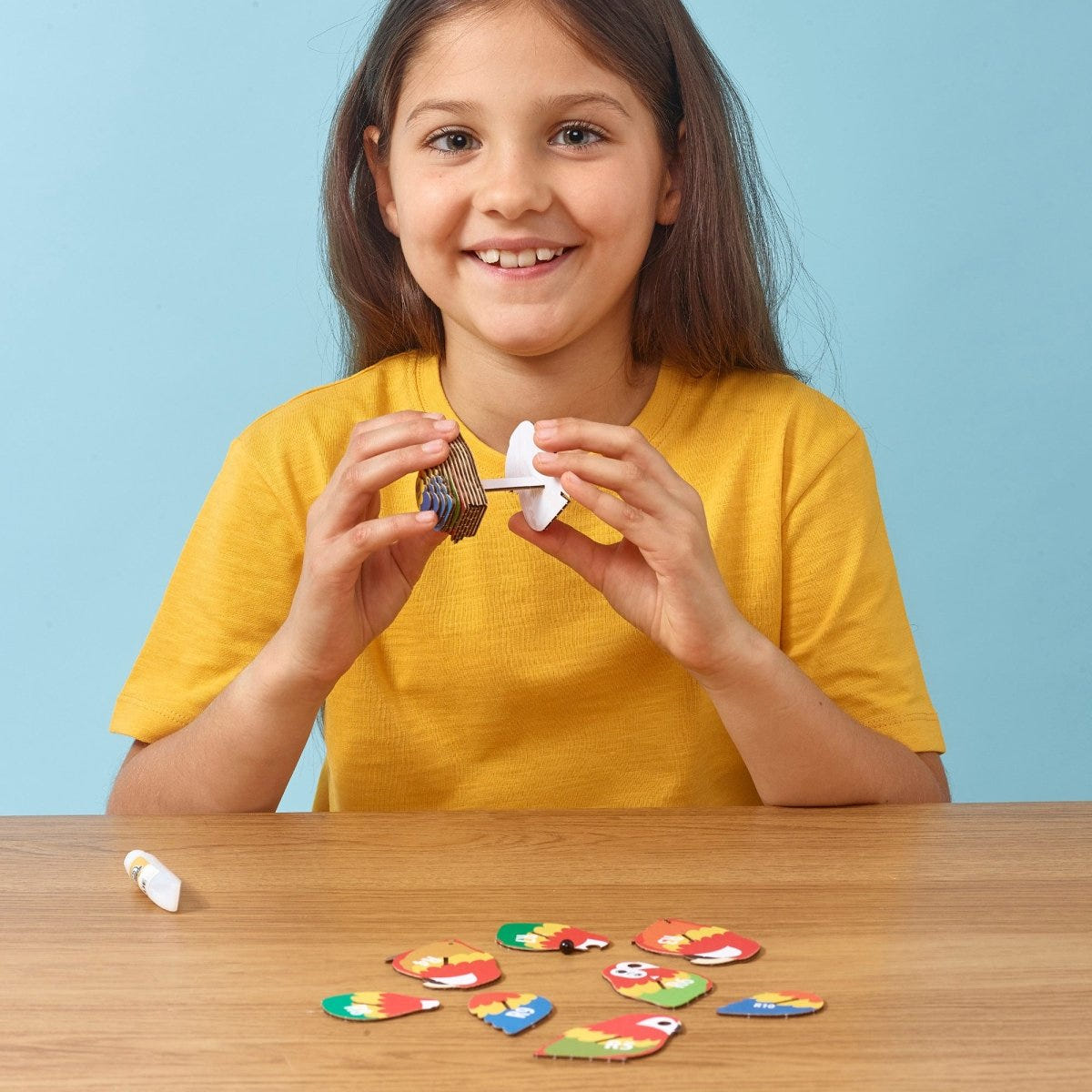 EUGY Parrot 3D cardboard model kit - child assembling the model