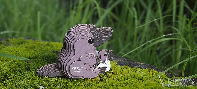 EUGY Platypus card model on moss beside tall grass, close lifestyle view