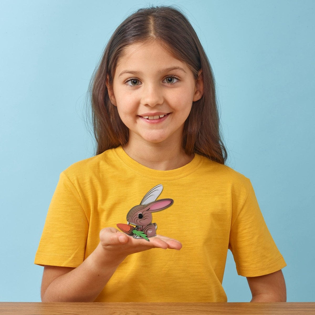 EUGY Rabbit 3D cardboard model kit - child with the finished model