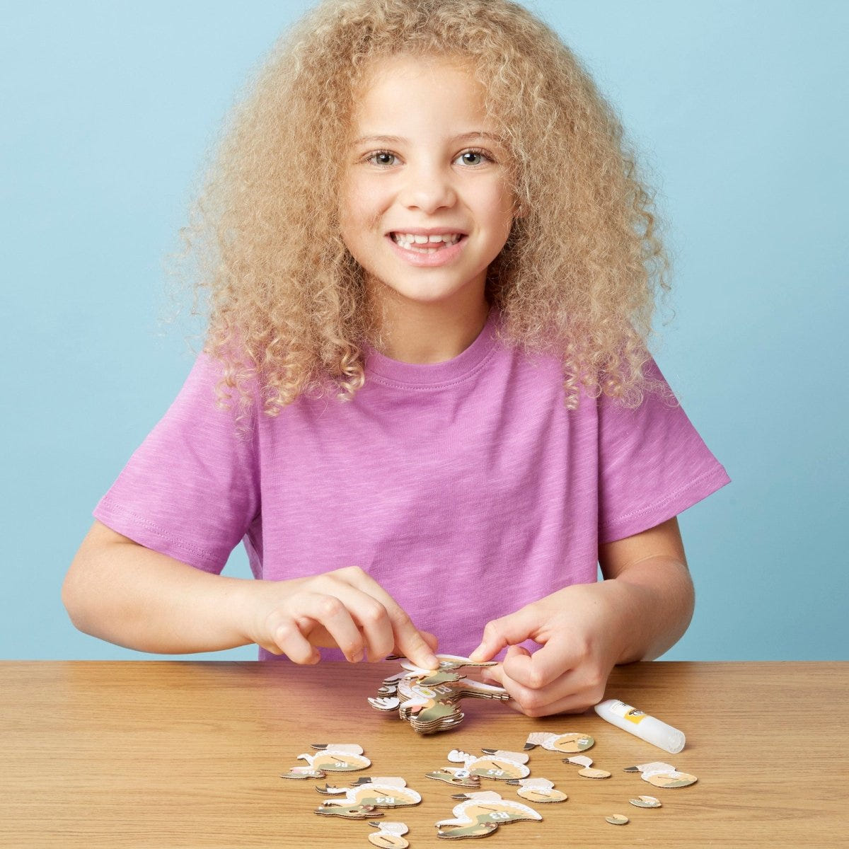 EUGY Raptor 3D cardboard model kit - child assembling the model