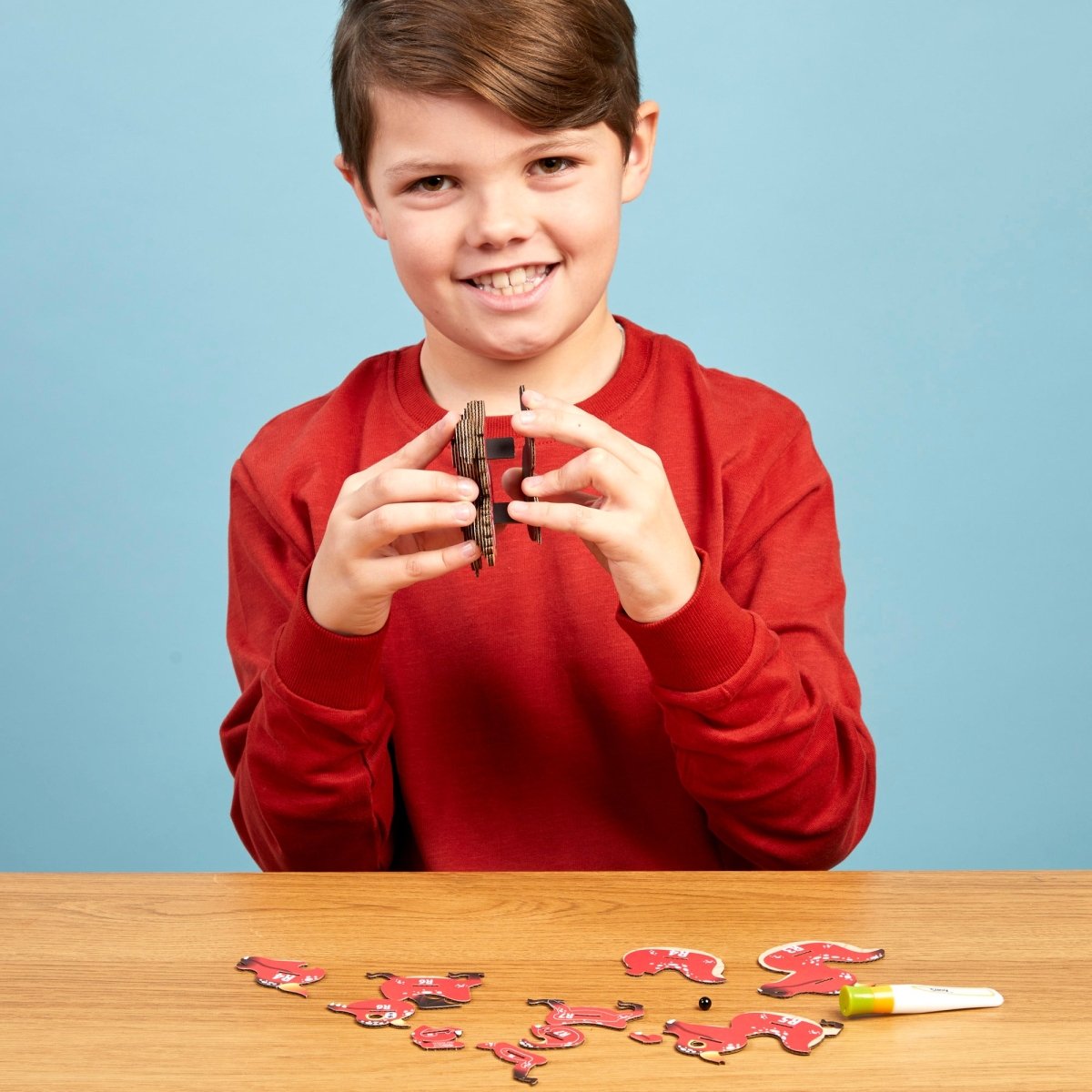 EUGY Red Dragon 3D cardboard model kit - child assembling the model