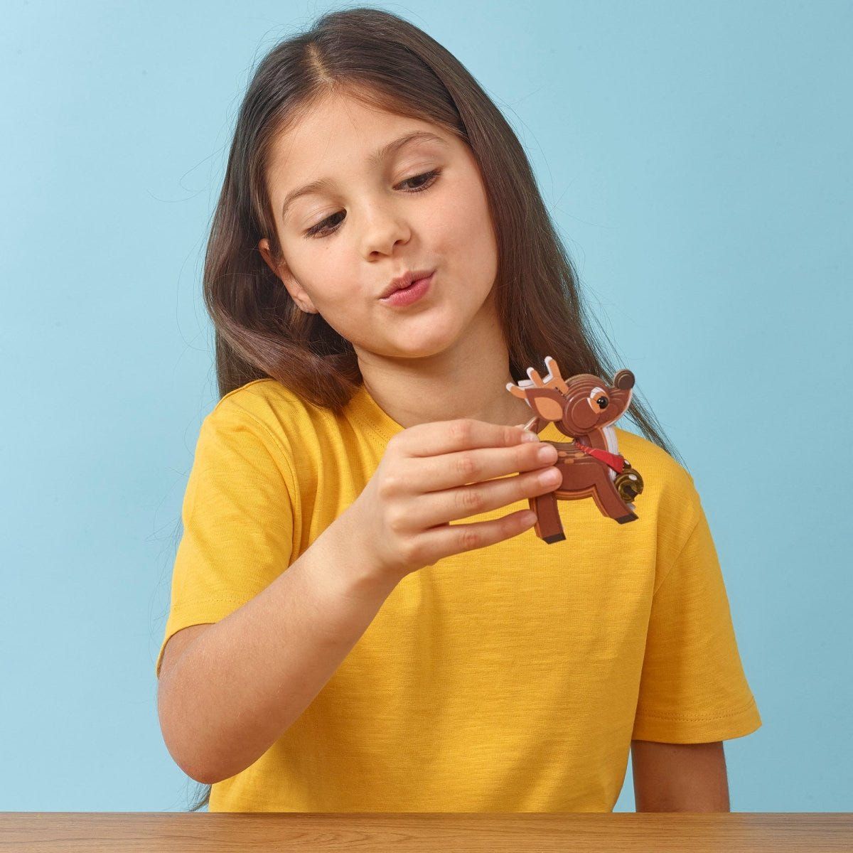 EUGY Reindeer 3D cardboard model kit - child with the finished model