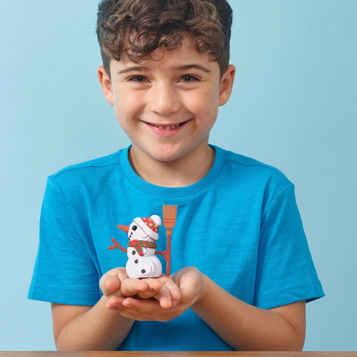 EUGY Snowman 3D cardboard model kit - child with the finished model