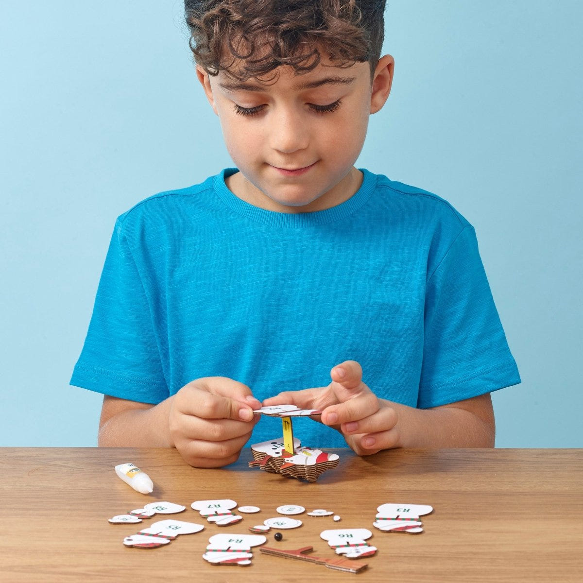 EUGY Snowman 3D cardboard model kit - child assembling the model