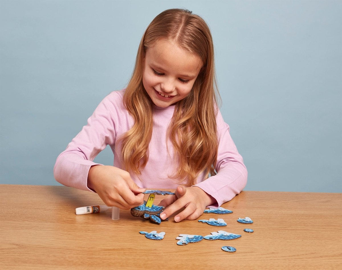 EUGY Stego 3D cardboard model kit - child assembling the model