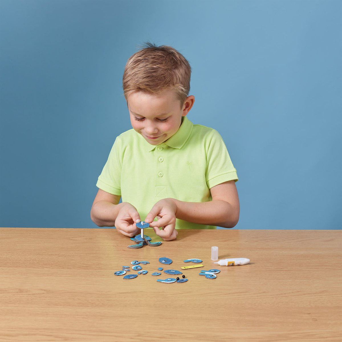 EUGY Turtle 3D cardboard model kit - child assembling the model