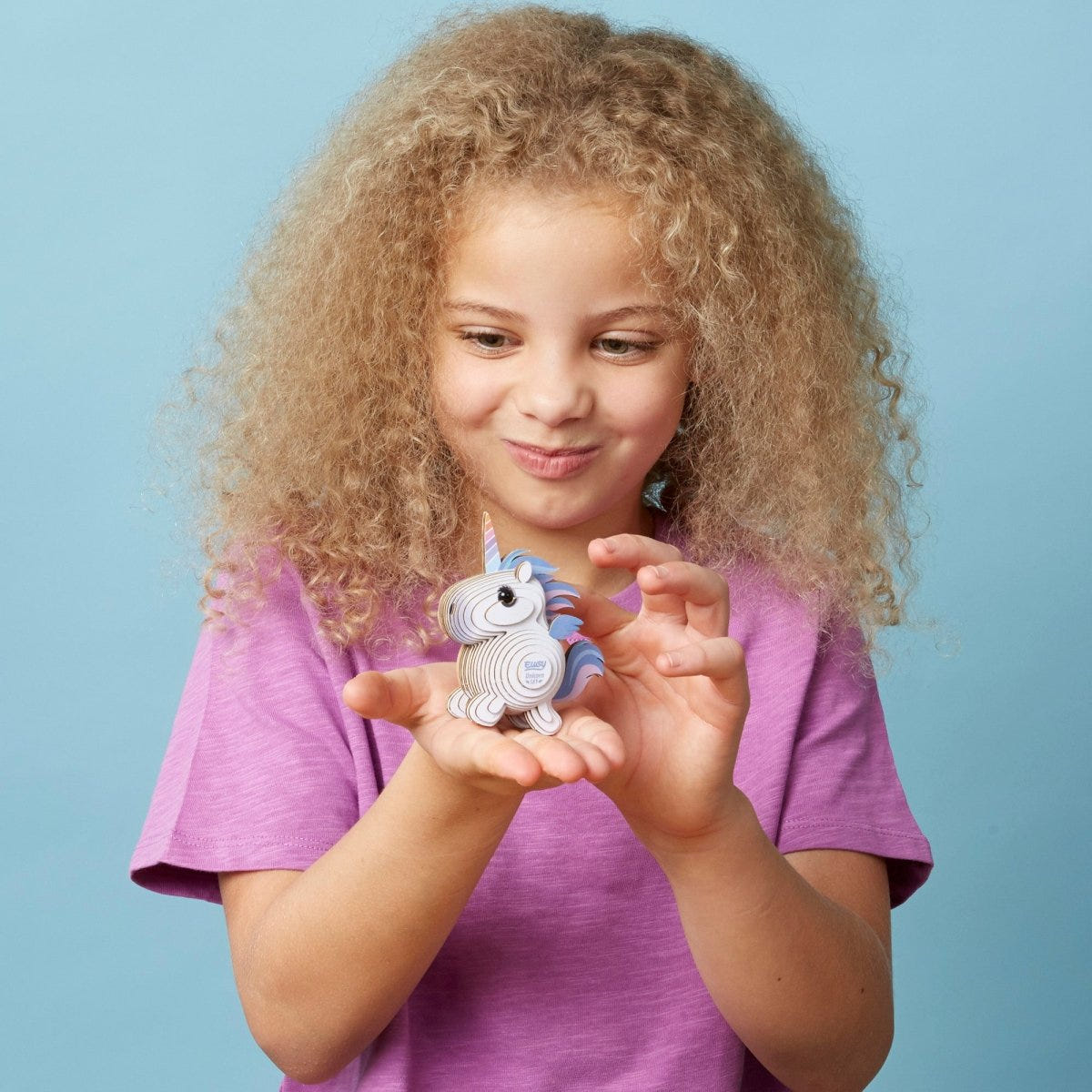 EUGY Unicorn Sky 3D cardboard model kit - child with the finished model