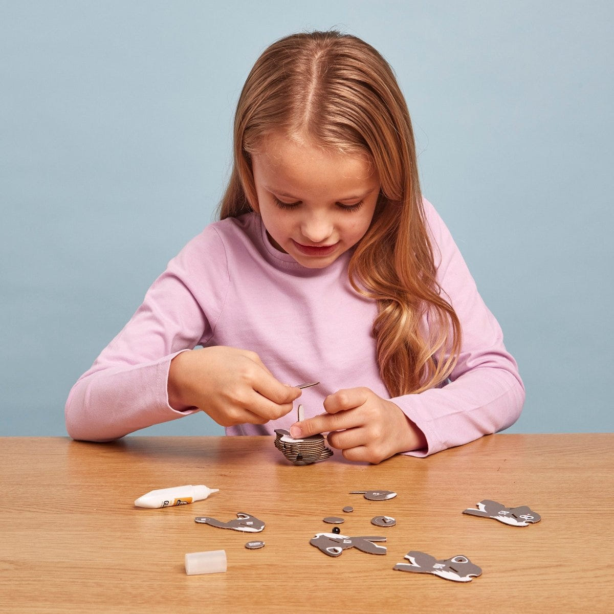 EUGY Wolf 3D cardboard model kit - child assembling the model