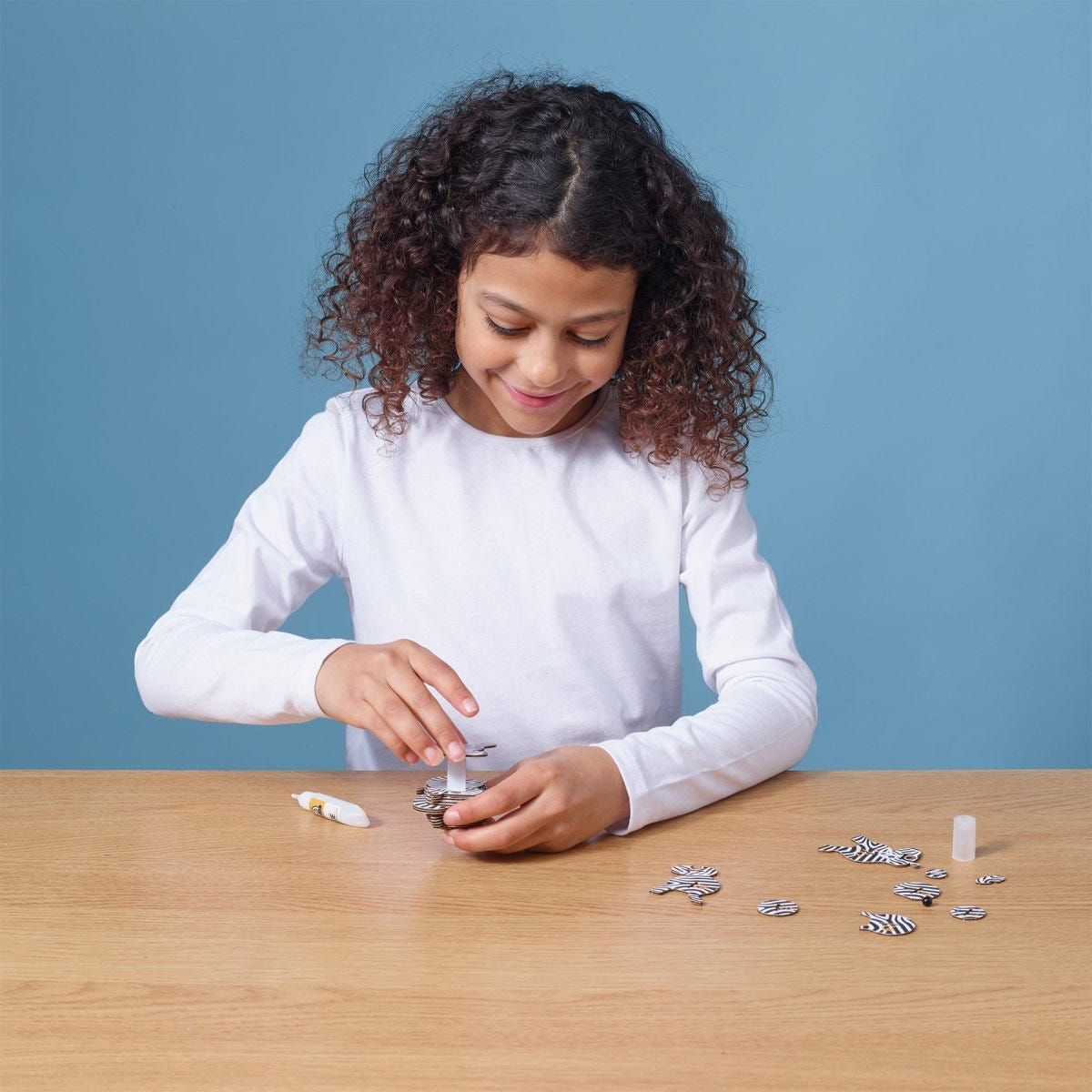 EUGY Zebra 3D cardboard model kit - child assembling the model