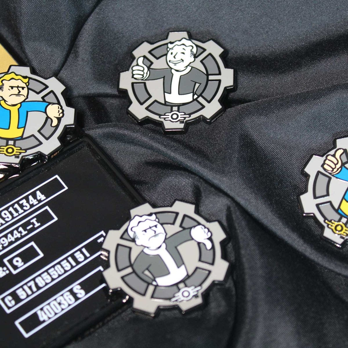 Fallout Decision Coins displayed with Vault-Tec props on black fabric, lifestyle shot