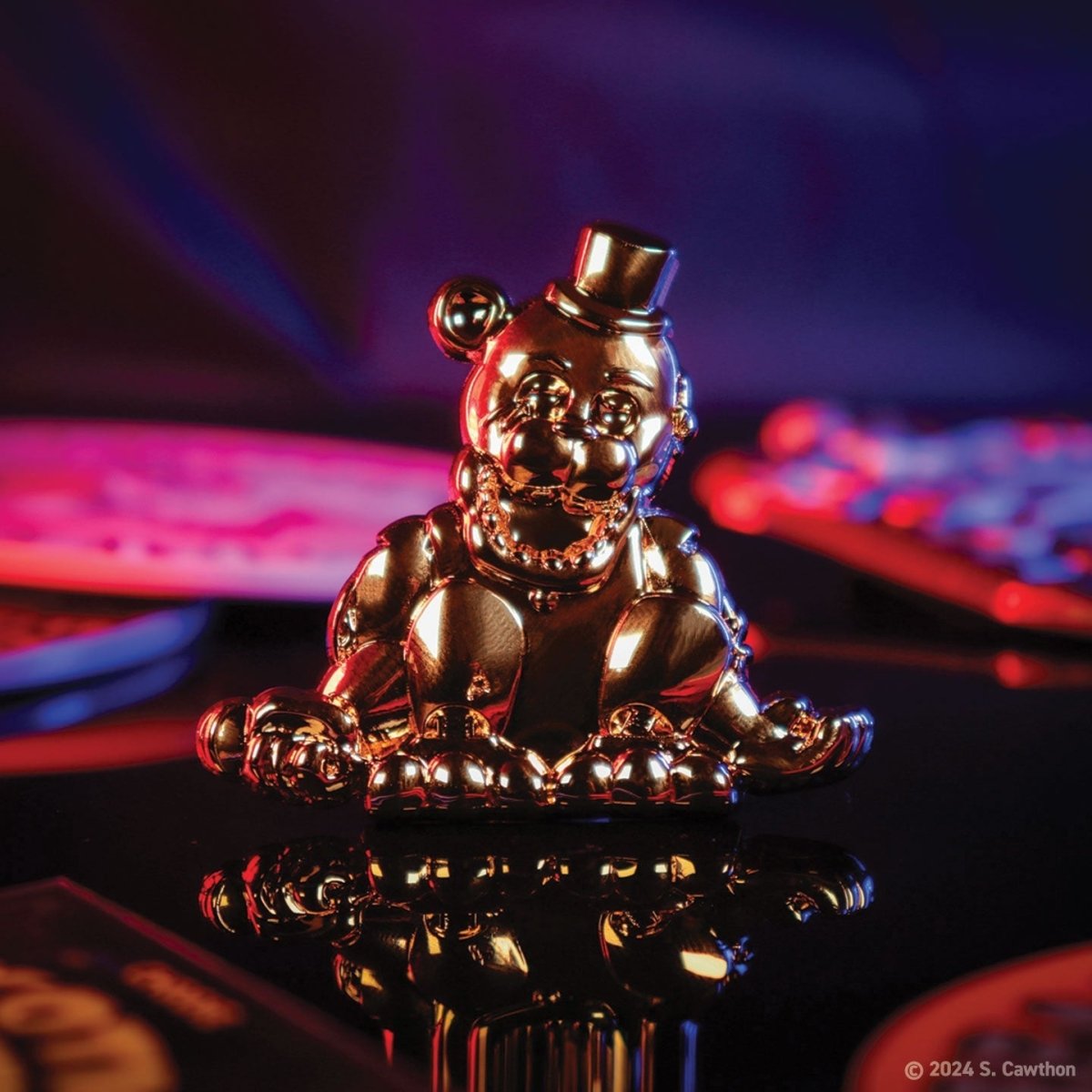 Five Nights at Freddy's Golden Freddy pin badge gleaming in a dark neon-lit lifestyle shot