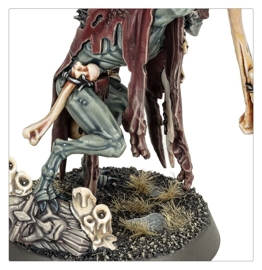 Close-up of the painted Abhorrant Cardinal's clawed feet and bone-strewn base