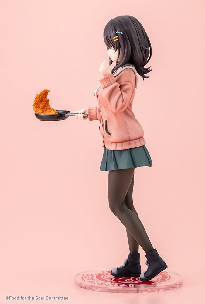 Left side view of the Mako Kawai statue in pink cardigan and green skirt with frying pan