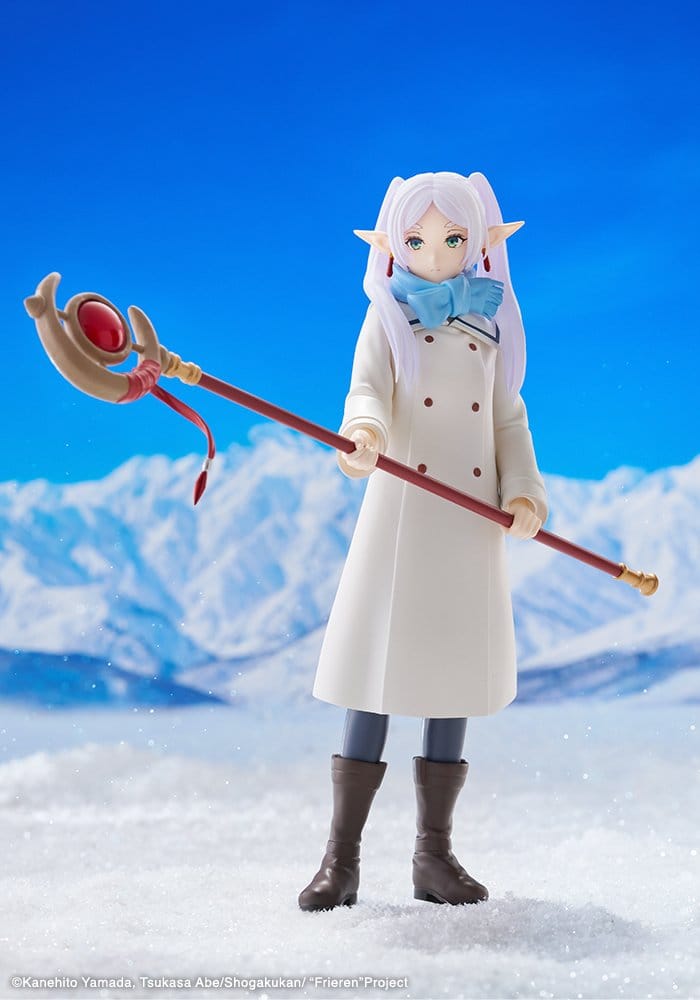 Frieren Oshi Works statue by Kotobukiya in white coat and blue scarf against a snowy mountain backdrop