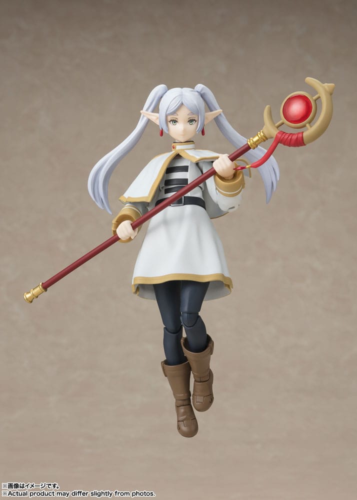 Bandai S.H.Figuarts Frieren figure mid-stride with staff raised, posed on a beige backdrop