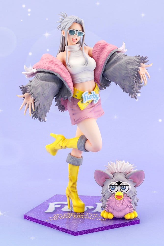 Furby Bishoujo figure beside mini Furby on purple Furby logo base, front view on lilac backdrop