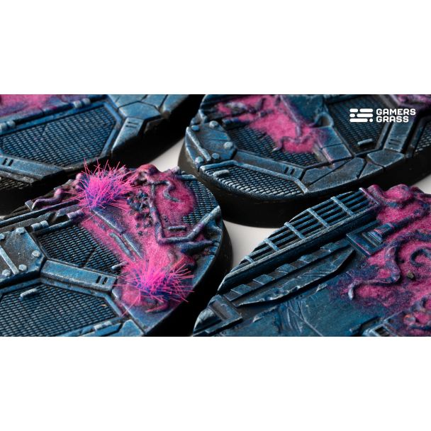 Close-up of Gamers Grass Alien Infestation oval bases with pink alien tufts over blue metal plating