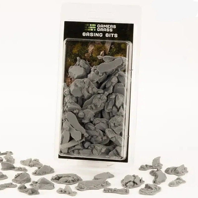 Gamers Grass Basing Bits Rocks pack with unpainted grey rock pieces scattered in front