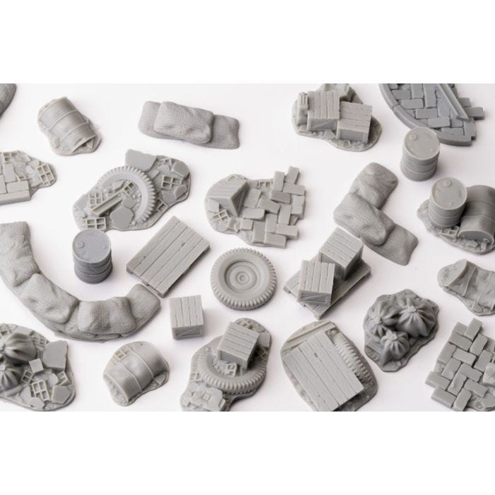 Gamers Grass Urban Warfare basing bits laid out: tyres, drums, crates and broken rubble