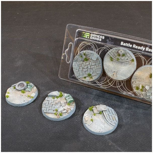 Gamers Grass Urban Warfare 50mm Battle Ready Bases with rubble and paving, beside their pack of three