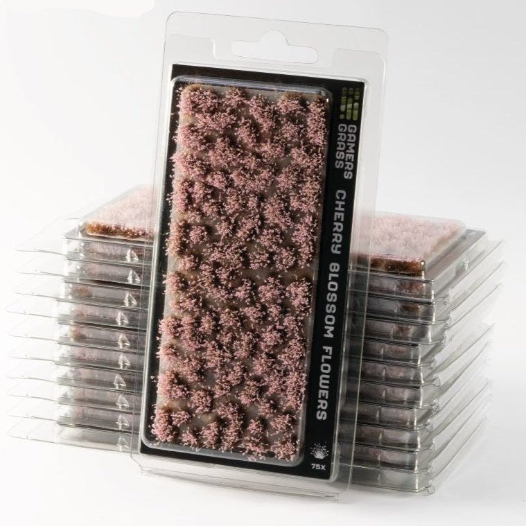 Gamers Grass Cherry Blossom Flowers tufts in blister packs, stacked, with pink blossom