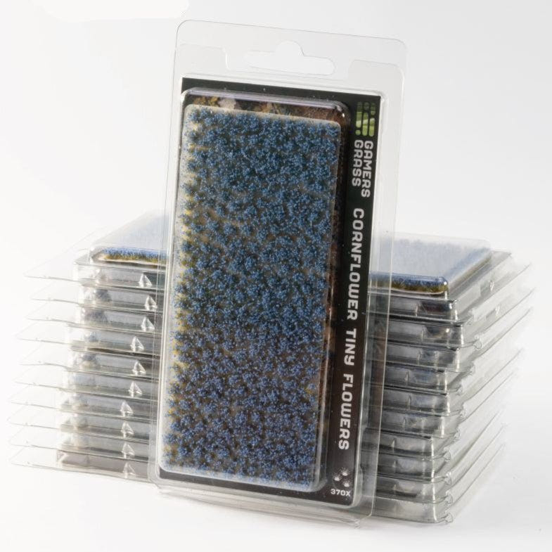 Gamers Grass Cornflower Tiny Flowers tufts in blister packaging, shown with stacked packs