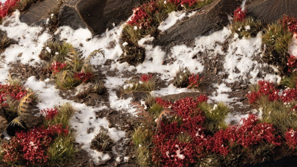 Gamers Grass Laliguras red flowers on a snowy rocky scenery base with grass tufts