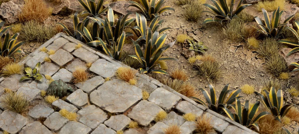 Gamers Grass laser-cut agave plants used on a scenic base among paving stones and dry grass