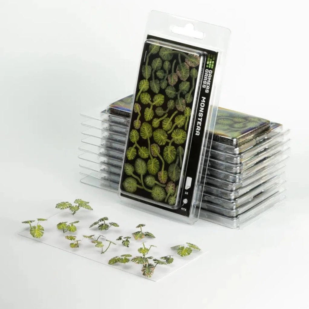 Gamers Grass Laser Plants Monstera blister packs with assembled split-leaf plants in front