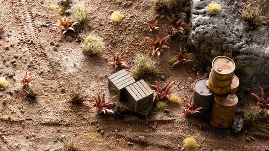 Gamers Grass Red Aloe laser plants on a desert diorama with crates, oil drums and tufts