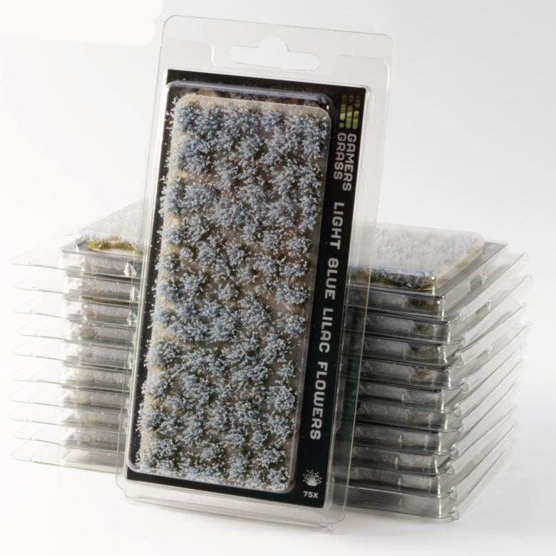 Gamers Grass Light Blue Lilac Flowers tufts in blister packs, stacked, with pale blue blooms