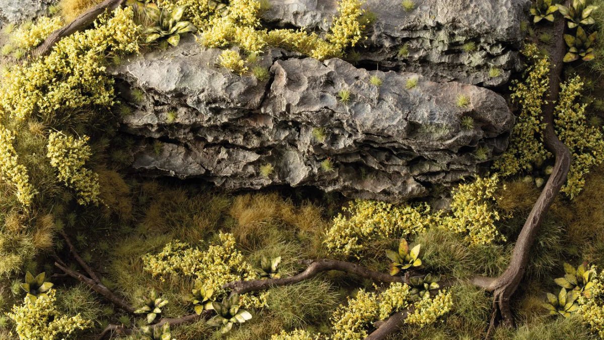 Gamers Grass Light Green Shrubs tufts around a mossy rock on a scenic base