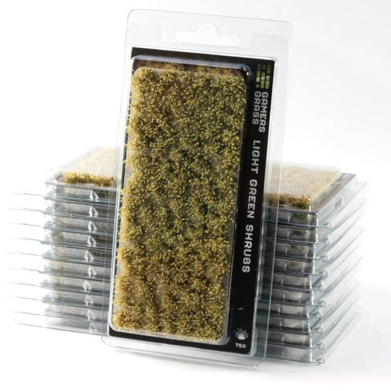 Gamers Grass Light Green Shrubs tufts in blister packaging, shown with stacked packs