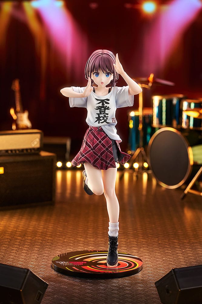 Nina Iseri 1/7 scale figure posed on a live music stage set with drums and amps behind her