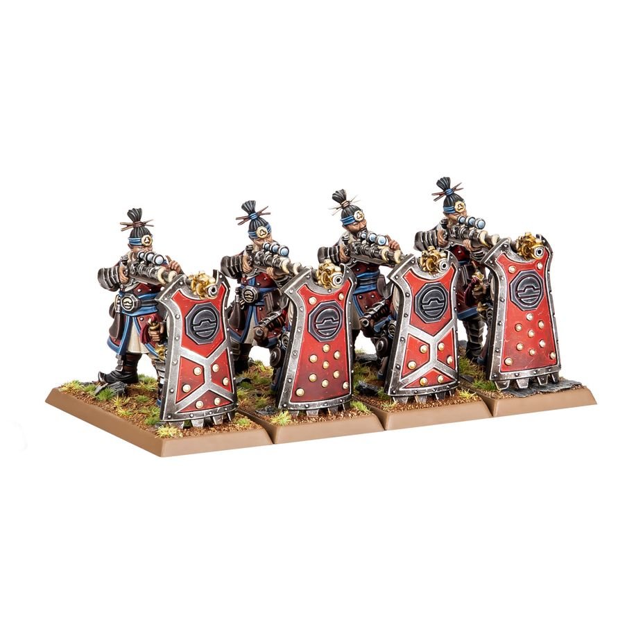 Four fantasy warrior miniatures with red shields and metallic armor, standing on a rectangular base with grass details against a plain white background.