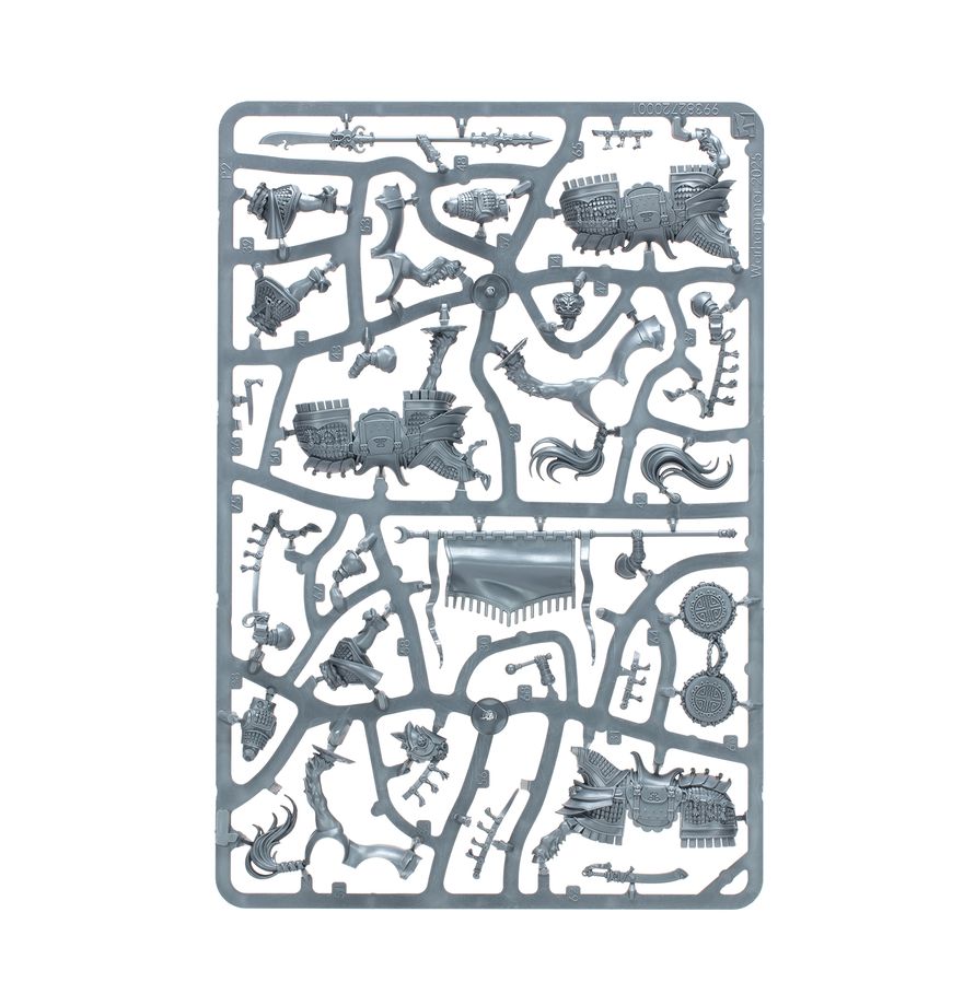 A rectangular gray plastic sprue containing various miniature model parts, including a castle, towers, roads, and decorative structures, isolated on a white background.