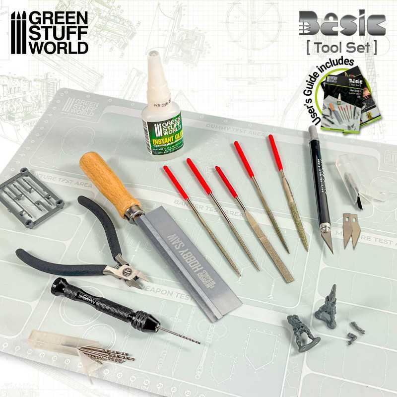 Green Stuff World Basic Tool Set laid out on a cutting mat beside a plastic miniature