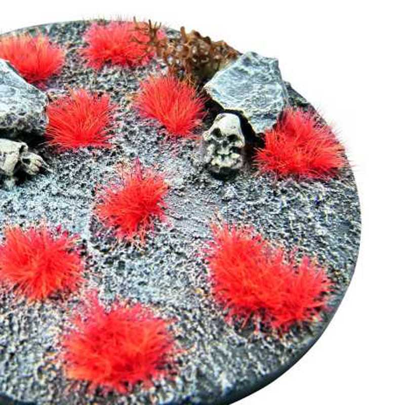 Close-up of Green Stuff World Neo-Mars Orange Martian fluor tufts on a grey rocky base with skull