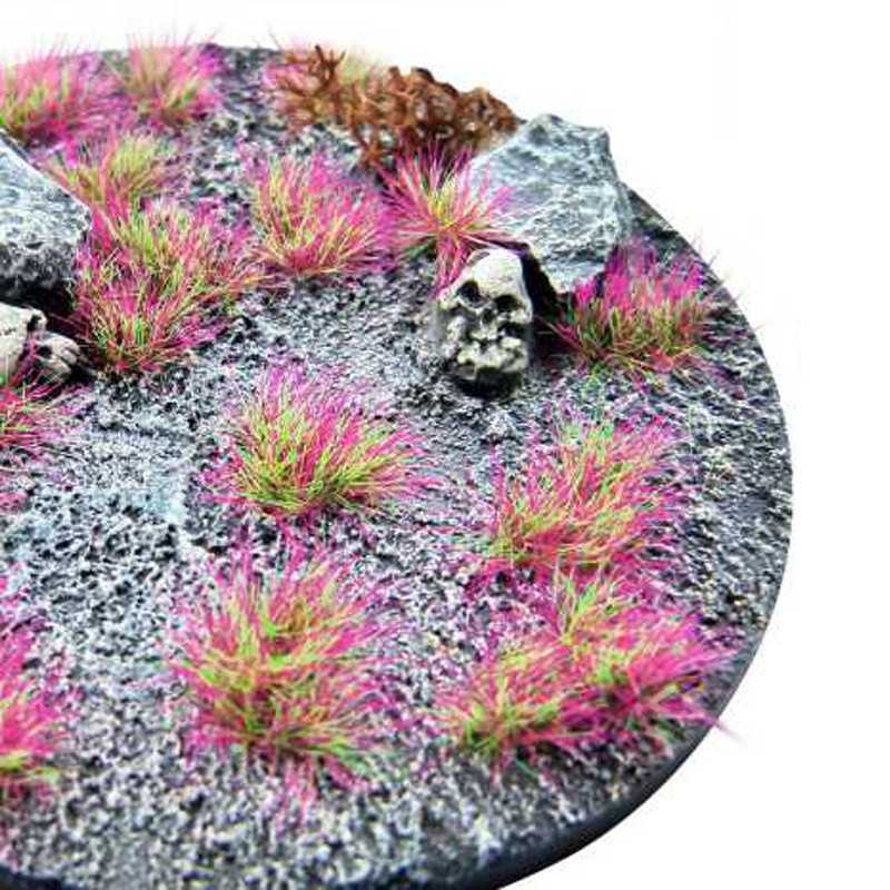 Green Stuff World Martian Fluor Tufts Punkpink Neon on a grey rocky miniature base, close-up