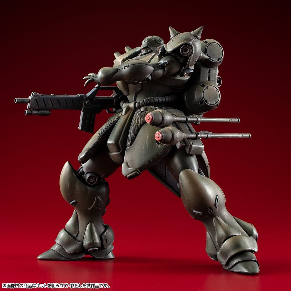 Megahouse VAKIT Geara Doga model kit in wide stance aiming its rifle, side view on red backdrop
