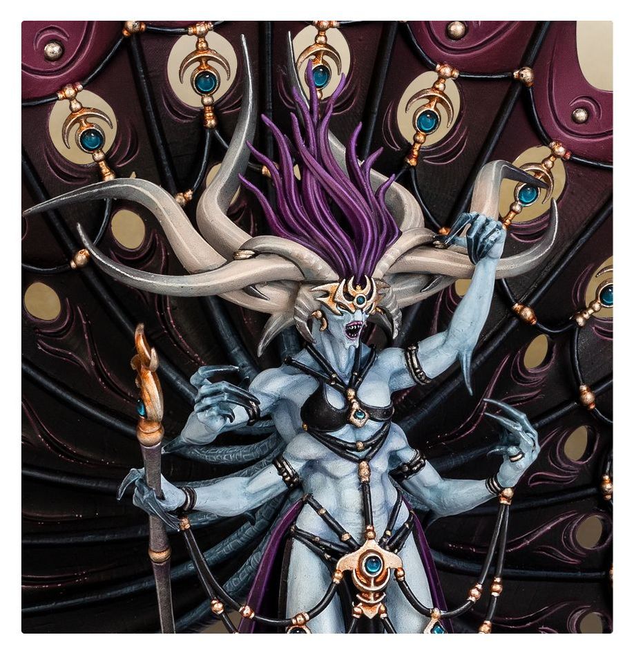Close-up of painted Dexcessa's pale blue four-armed torso, horned head and ornate staff