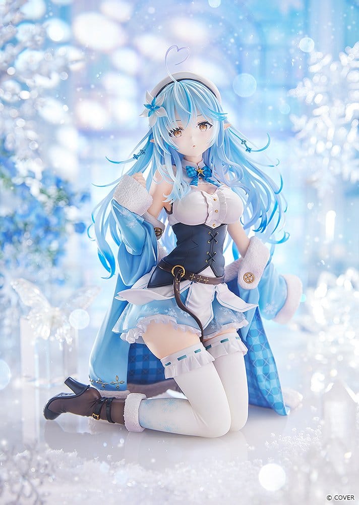 Yukihana Lamy 1/6 figure by Max Factory kneeling in blue coat and white beret against a wintry snowflake backdrop