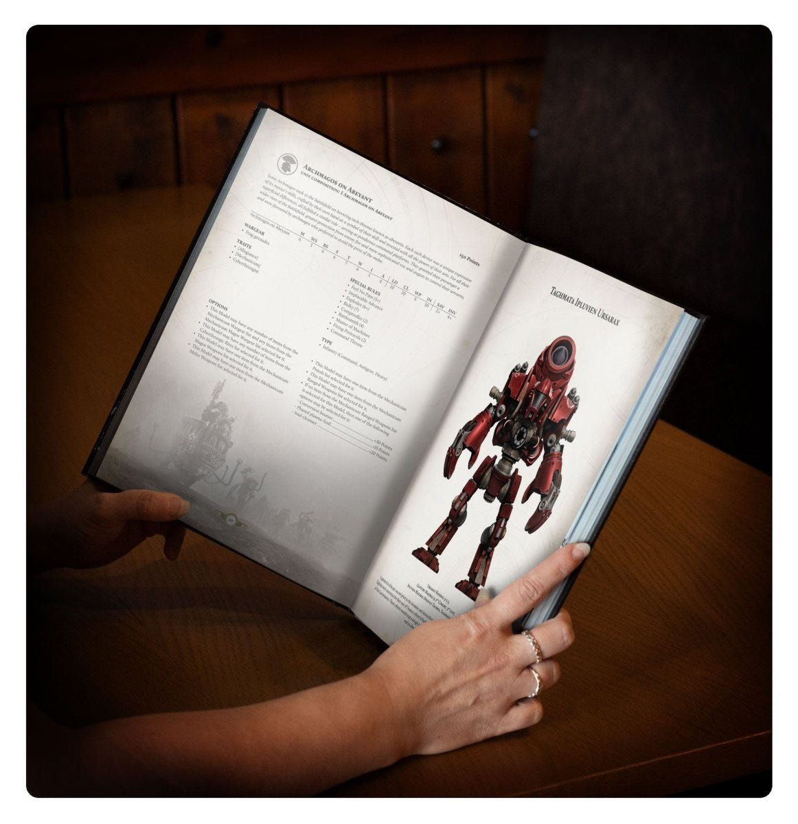 Reader holding the Horus Heresy Liber Mechanicum open at an automata rules page