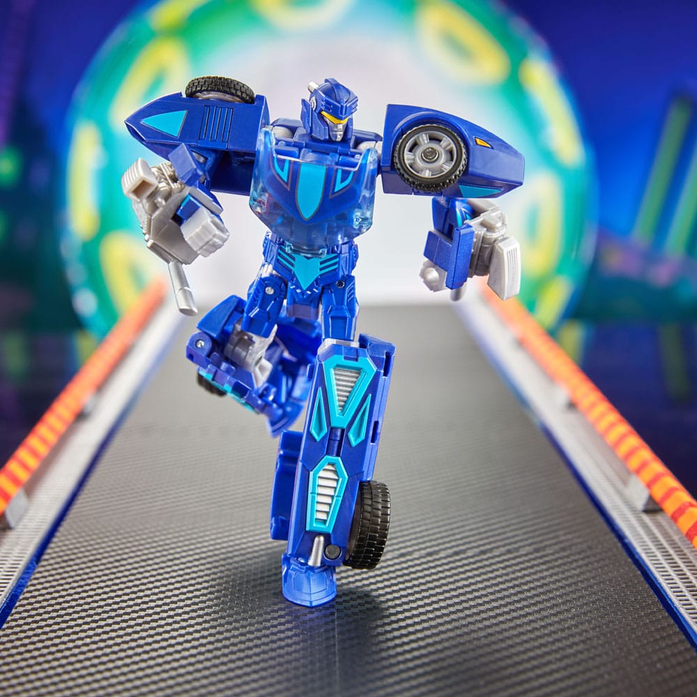 Twin Mill converting figure in robot mode, one leg forward, race track scene